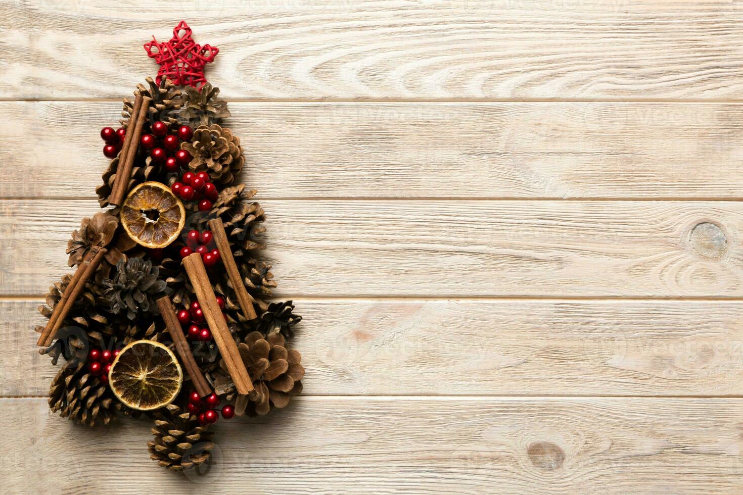 Christmas tree made from natural cones on colored background, view from above. New Year minimal concept with copy space photo