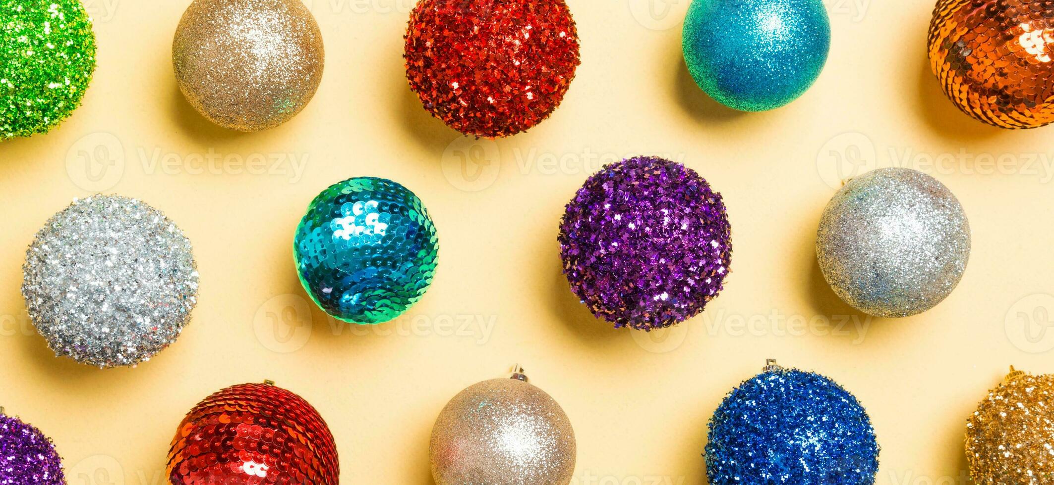 Top view Banner of colorful Christmas balls on yellow background. New Year time concept photo