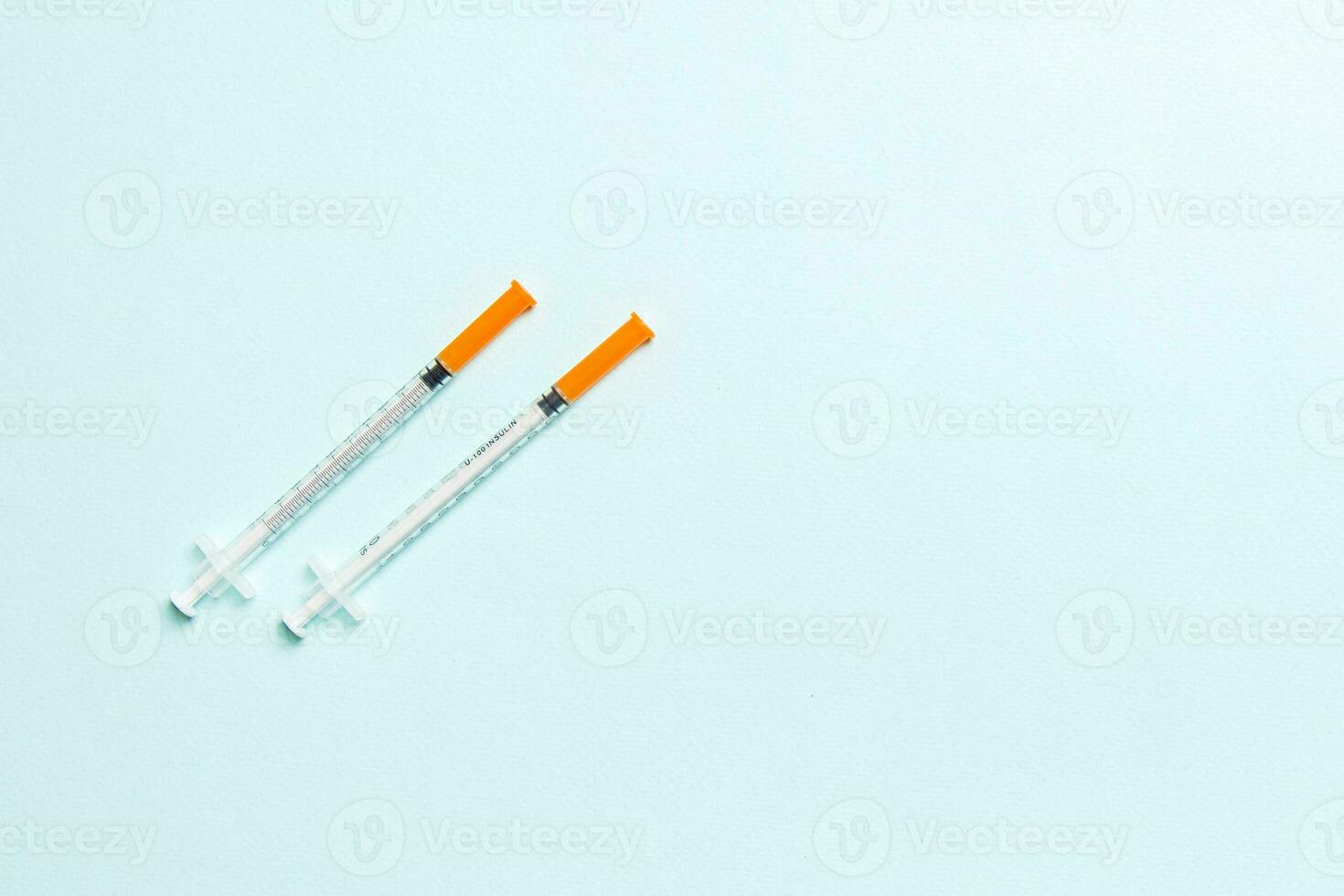 Top view of insulin syringes ready for injection on colorful background. Diabetic concept with copy space photo
