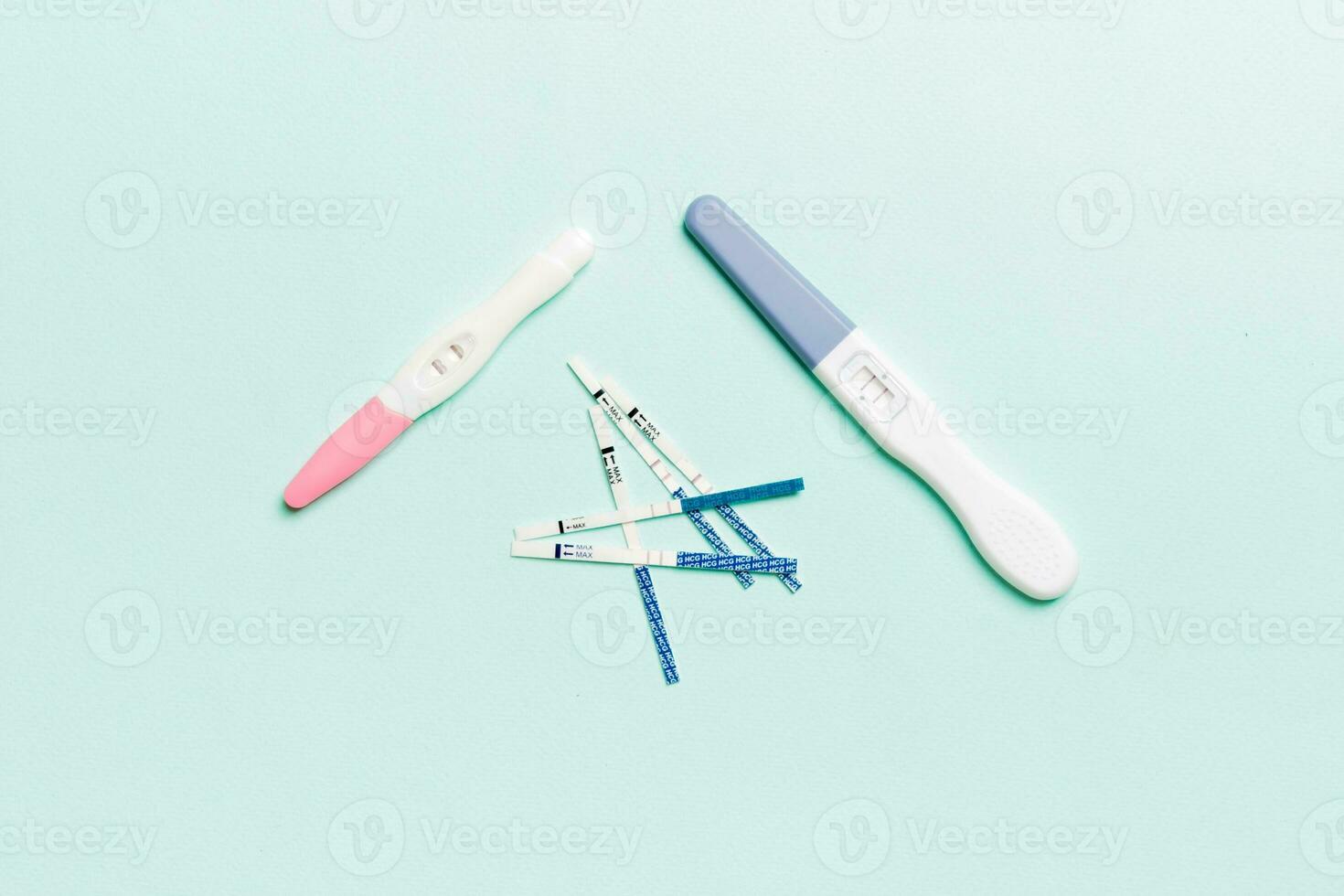 Colored Pregnancy test on colored background, top view with copy space photo