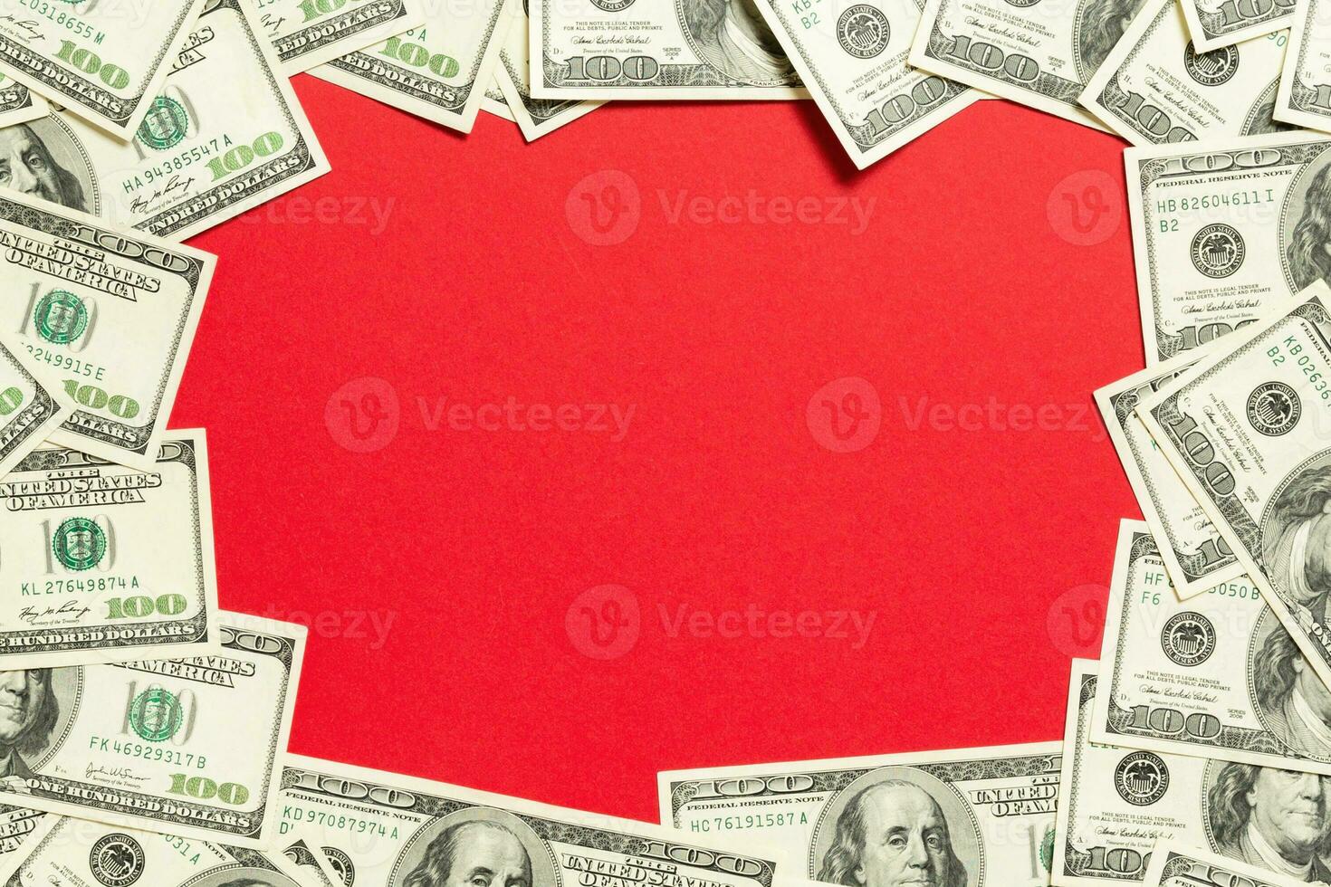 Frame made of dollars with copy space in the middle. Top view of business concept on red background with copy space photo