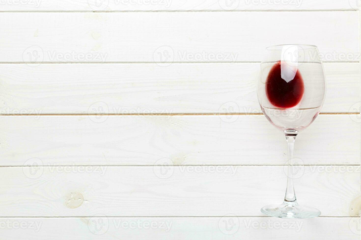 One glasses of red wine at wine tasting. Concept of red wine on colored background. Top view, flat lay design photo