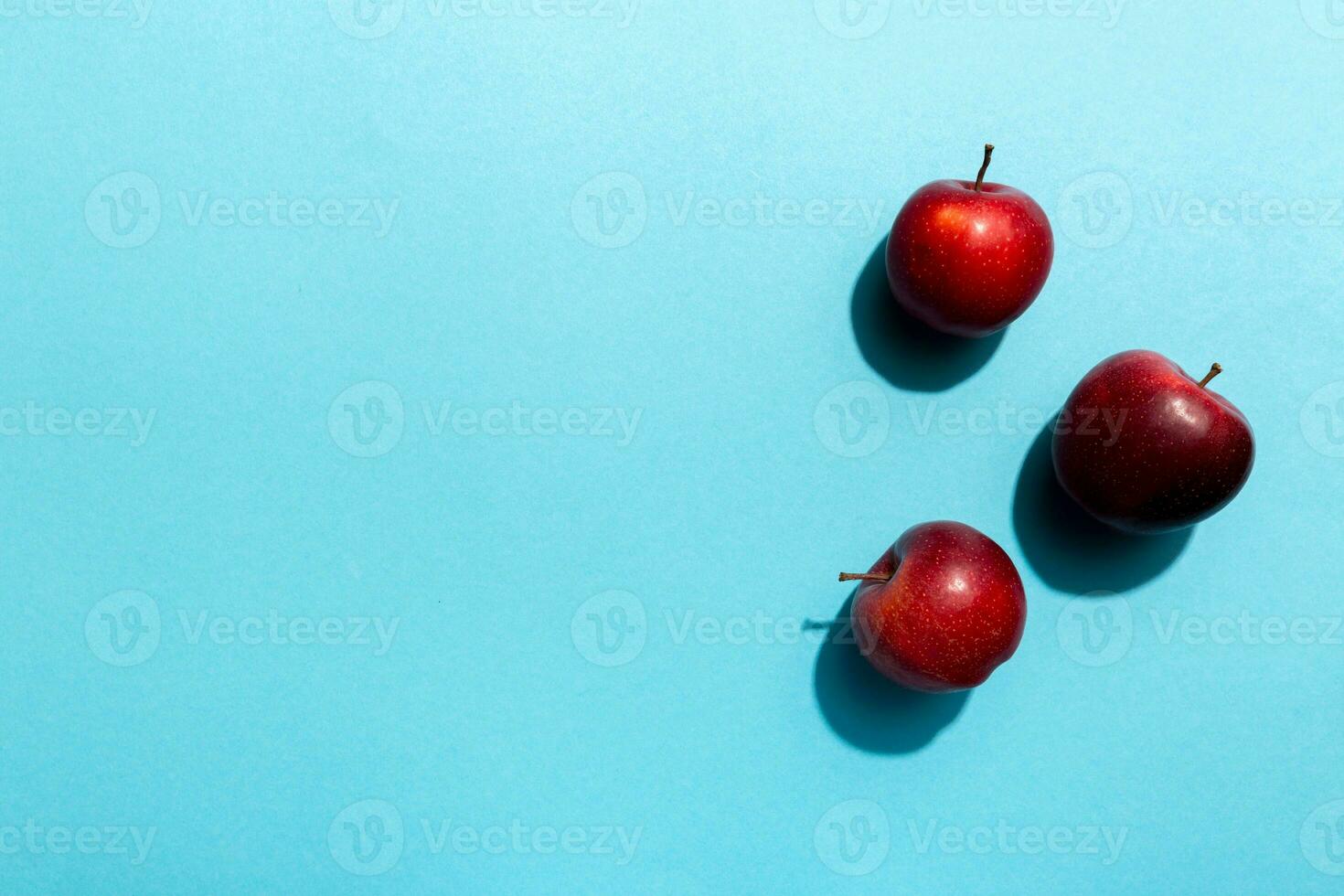 Many red apples on colored background, top view. Autumn pattern with fresh apple above view with copy space for design or text photo