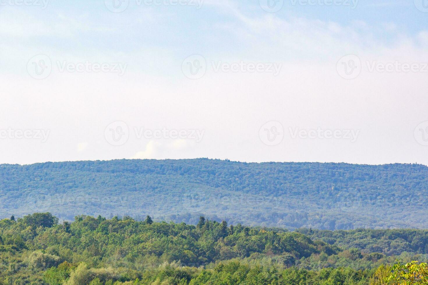 Green hills and sky landscape. Fresh plants background photo