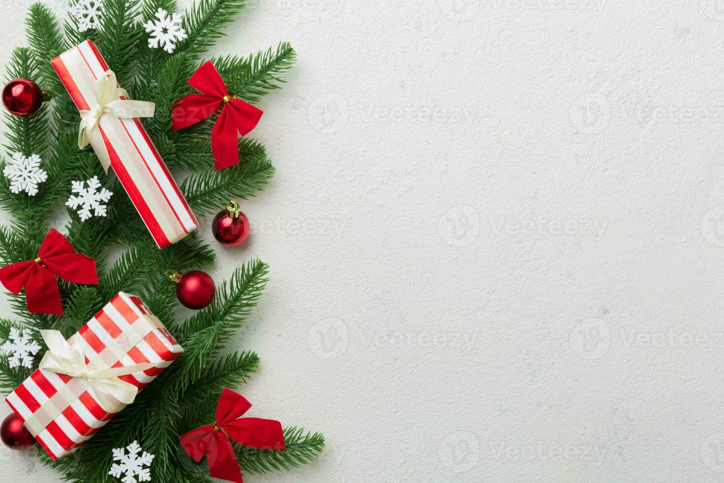 Christmas decorations and fir tree branch and gift boxon dark table. Top view frame with copy space photo