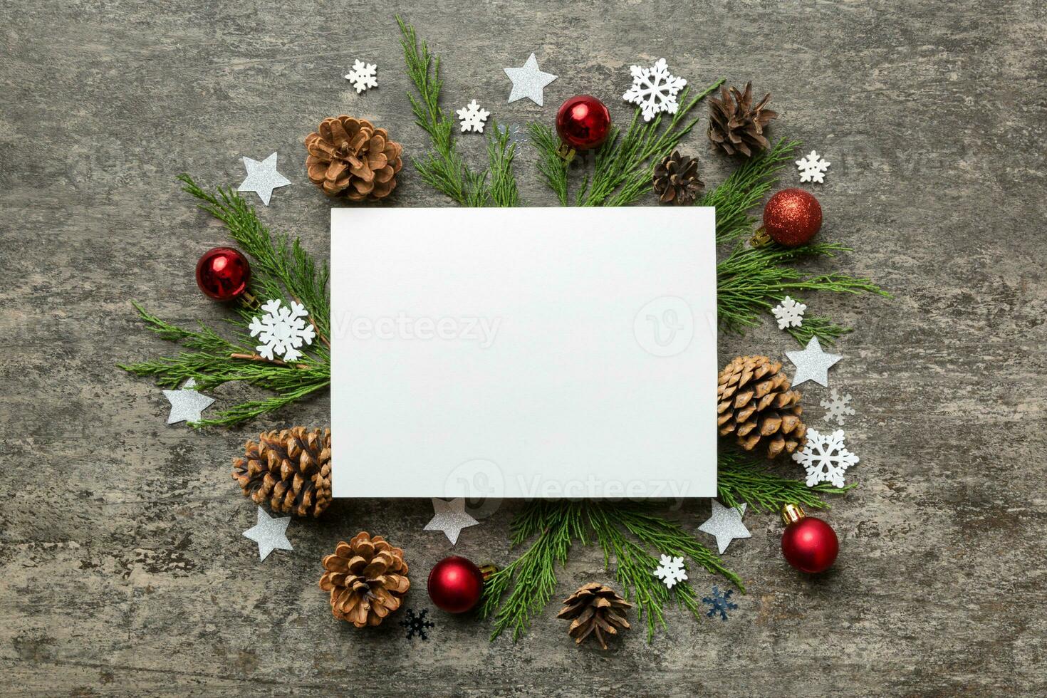 Flat lay Christmas composition. square Paper blank, pine tree branches, christmas decorations on Colored background. Top view, copy space for text photo