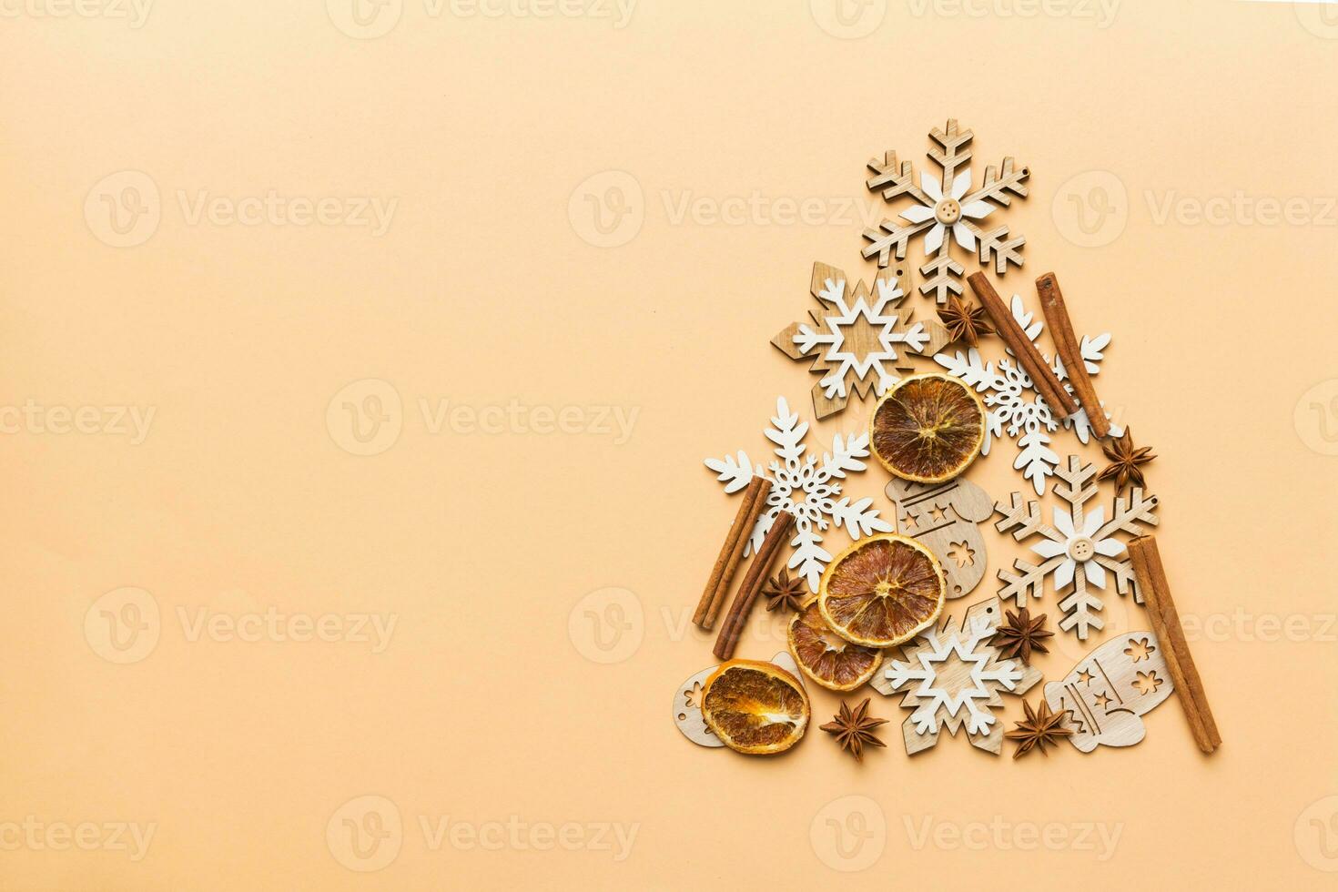 Christmas tree made from colored handmade ball decoration on colored background, view from above. New Year minimal concept with copy space photo