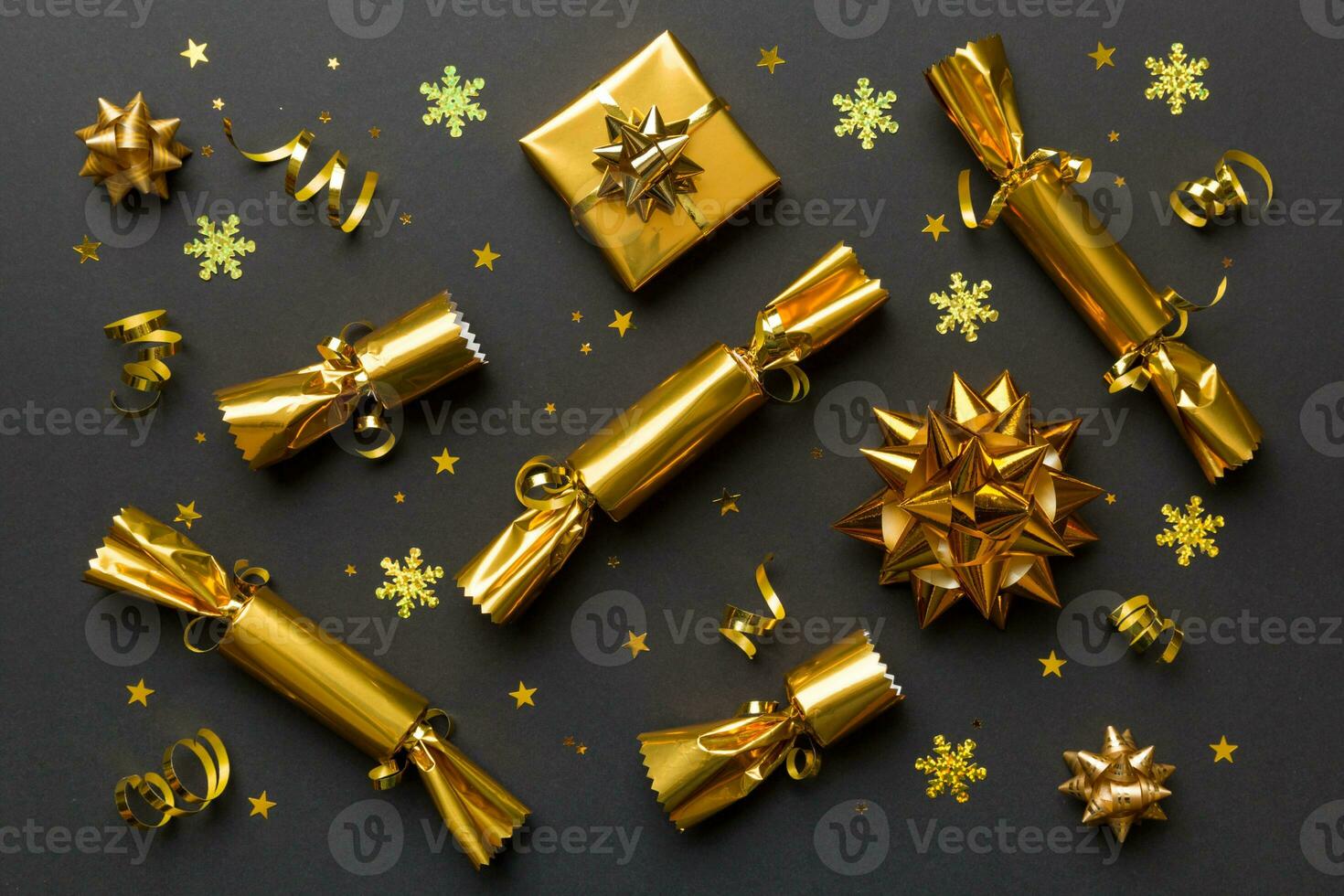 Christmas crackers with shiny confetti on color background, top view, copy space photo