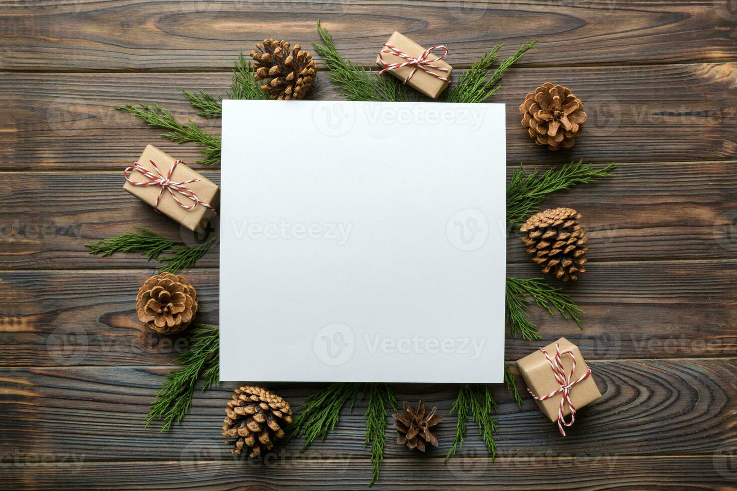 Flat lay Christmas composition. square Paper blank, pine tree branches, christmas decorations on Colored background. Top view, copy space for text photo