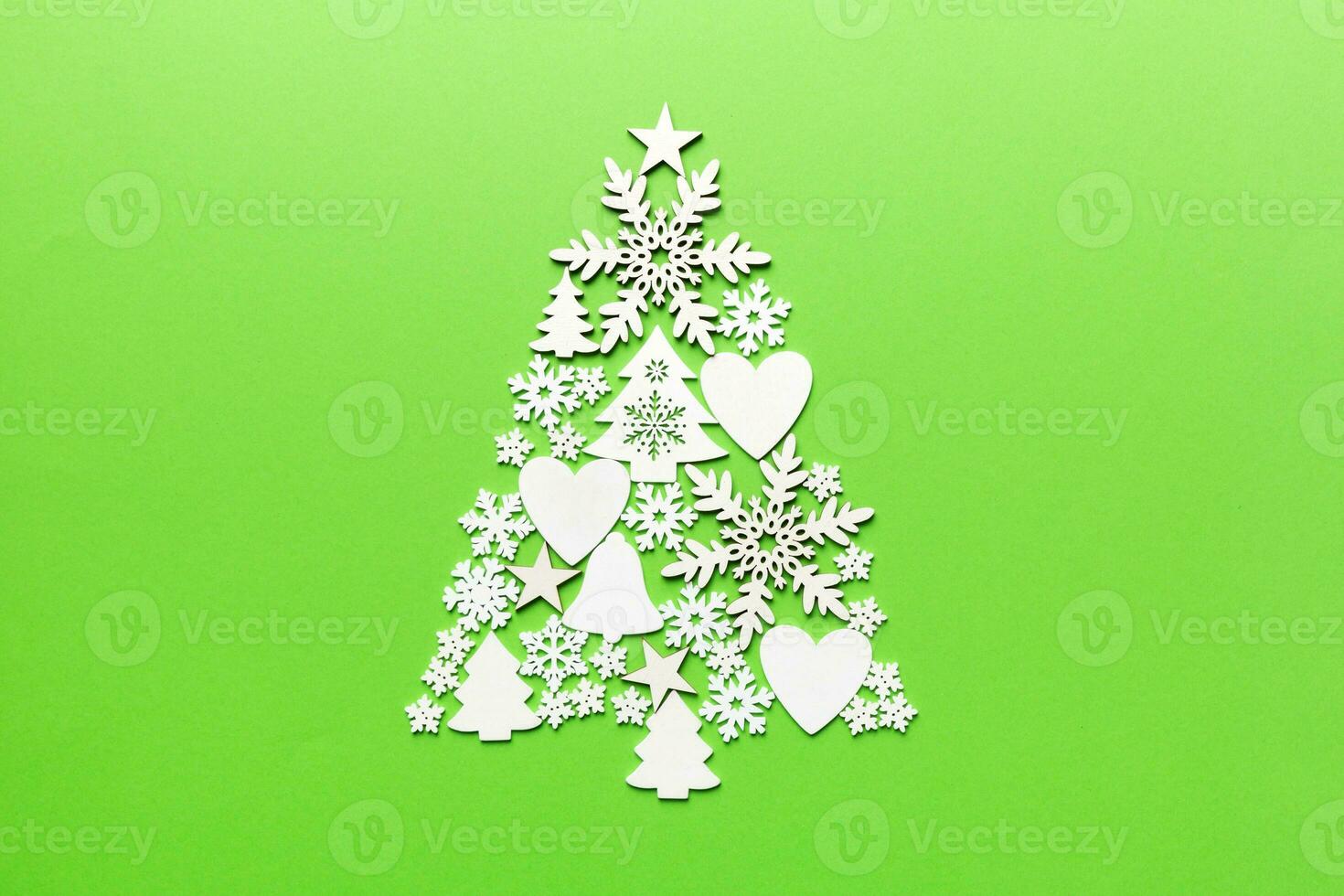 Christmas tree made from colored handmade ball decoration on colored background, view from above. New Year minimal concept with copy space photo