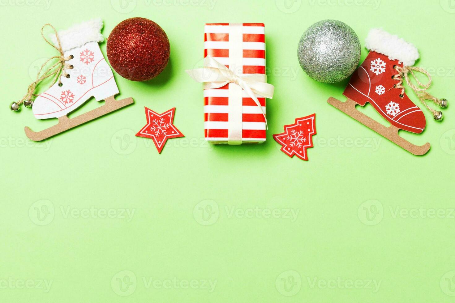 Top view Christmas ball, gift and creative decorations on colorful background. New Year holiday concept with copy space photo