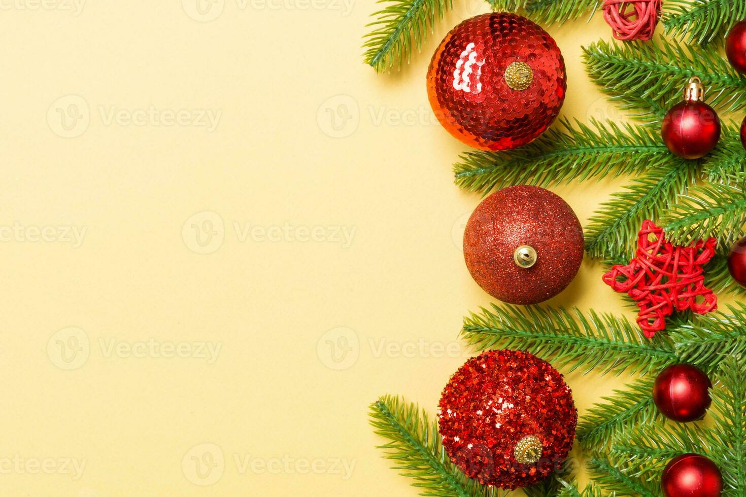 Christmas composition made of fir tree, balls and different decorations on colorful background. Top view of New Year Advent concept with empty space for your design photo