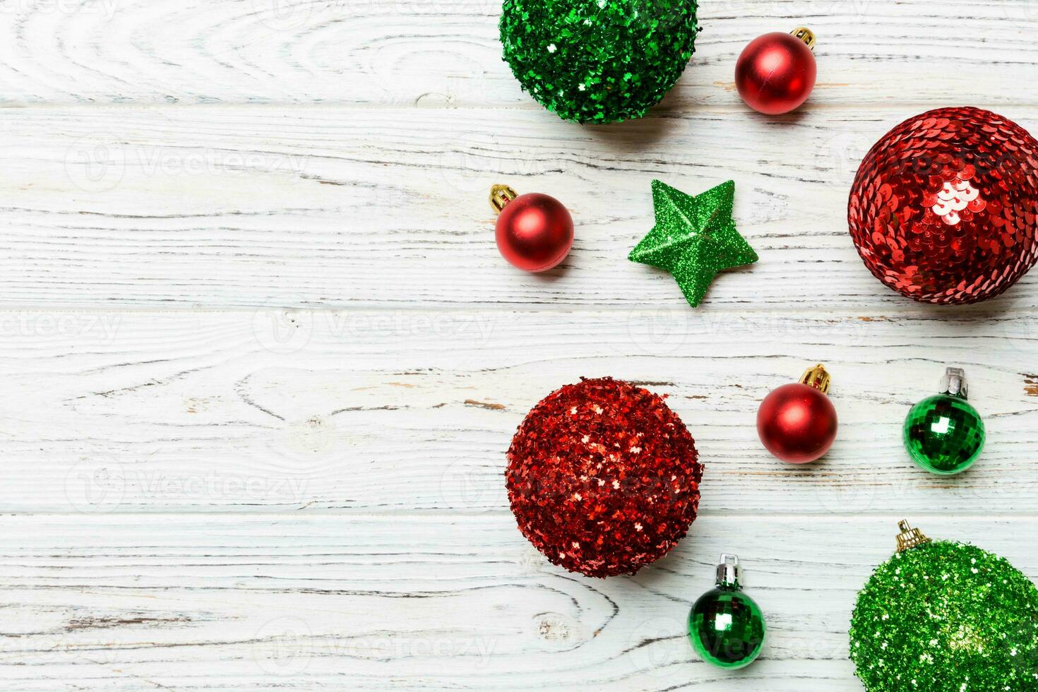 Creative set of New Year baubles and decorations on wooden background. Top view of Christmas time concept. Copy space photo