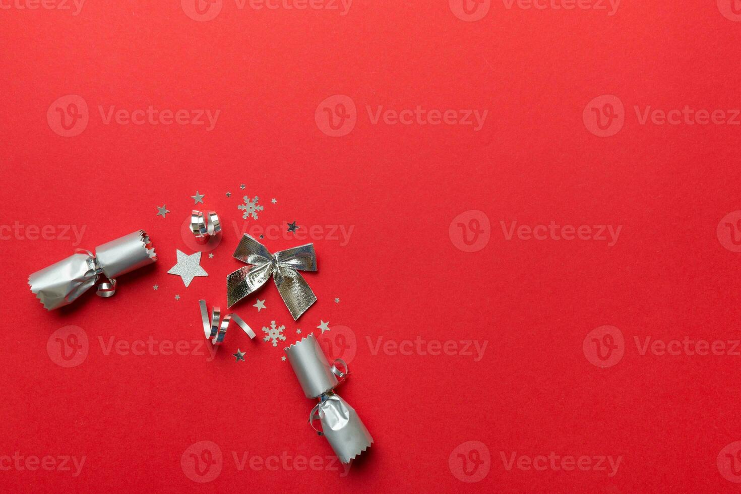 Christmas crackers with shiny confetti on color background, top view, copy space photo