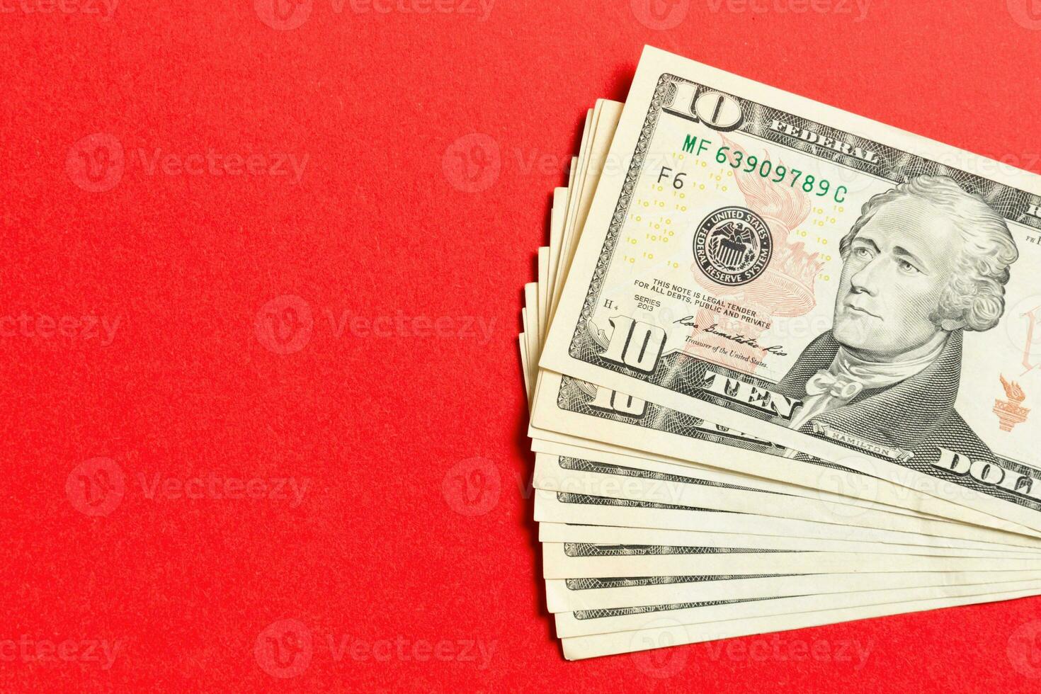 Top view of bundle of 10 dollar bill on colorful backgound. Business concept with copy space photo