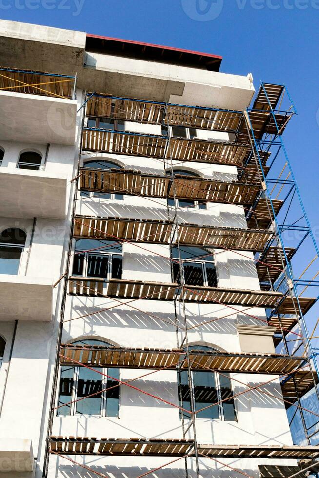 Extensive scaffolding for building a new house. Constraction of platforms for building works photo