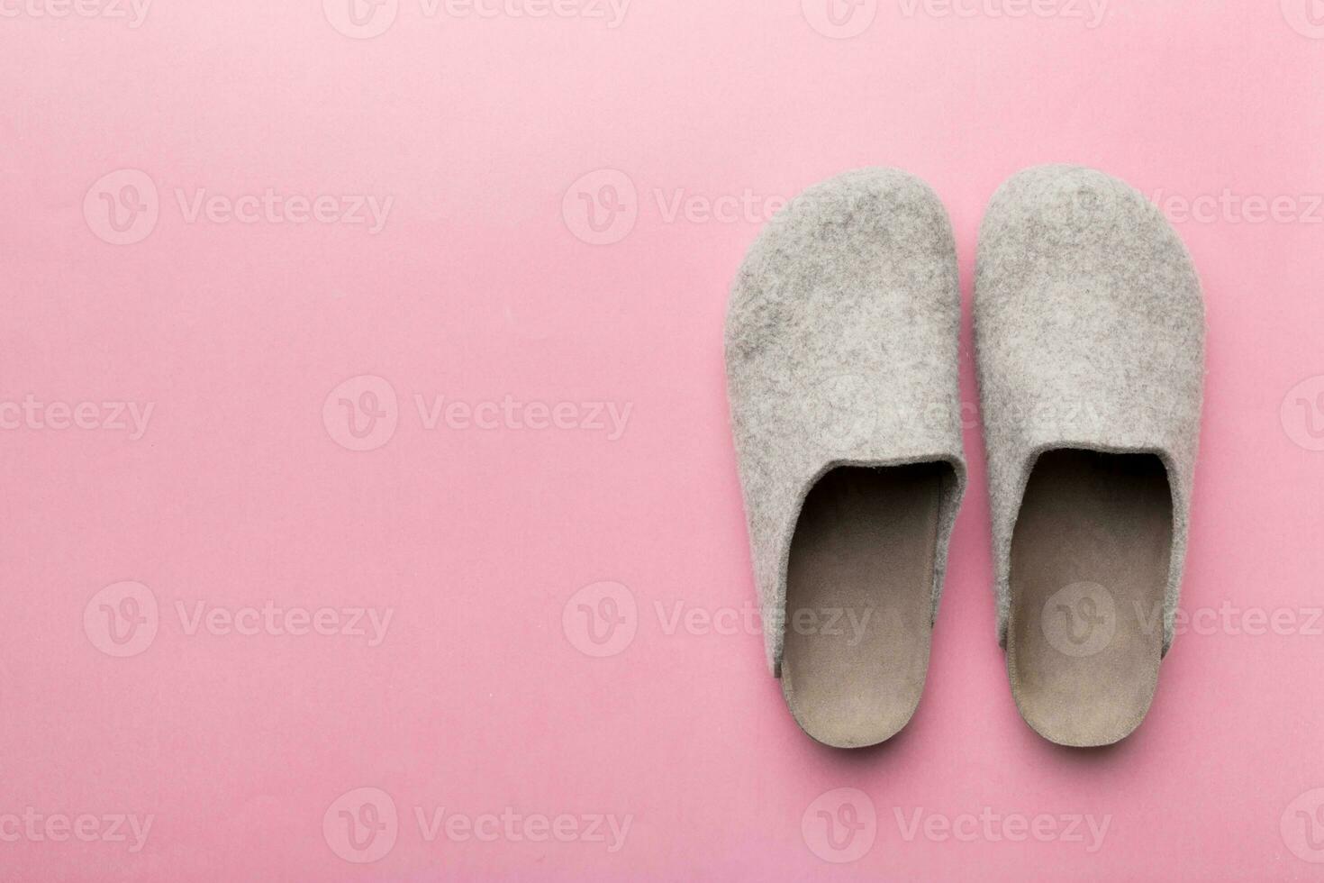 Warm winter women woolen slippers on colored background. Copy space for text photo