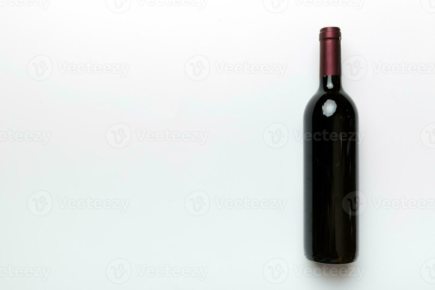 One Bottle of red wine on colored table. Flat lay, top view wth copy space photo