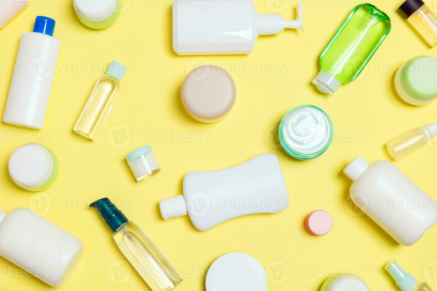 Group of plastic bodycare bottle Flat lay composition with cosmetic products on yellow background empty space for you design. Set of White Cosmetic containers, top view with copy space photo