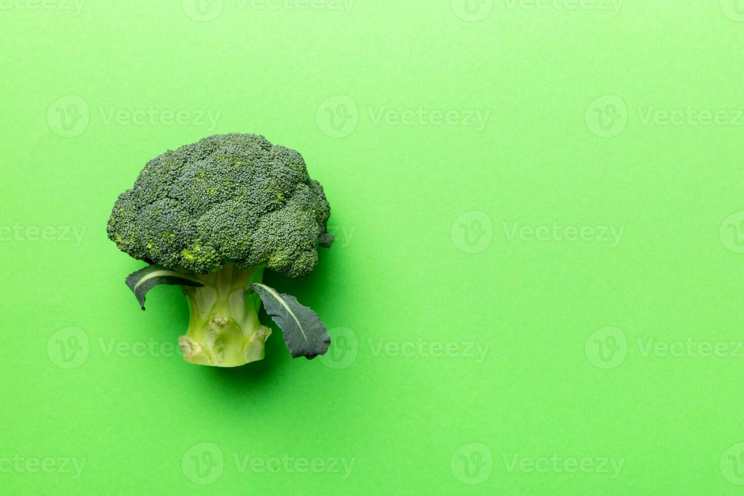 Top view fresh green broccoli vegetable on Colored background. Broccoli cabbage head Healthy or vegetarian food concept. Flat lay. Copy space photo