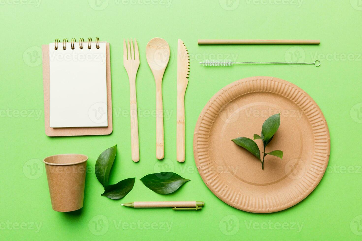 set of empty reusable disposable eco-friendly plates, cups, utensils on light white colored table background. top view. Biodegradable craft dishes. Recycling concept. Close-up photo