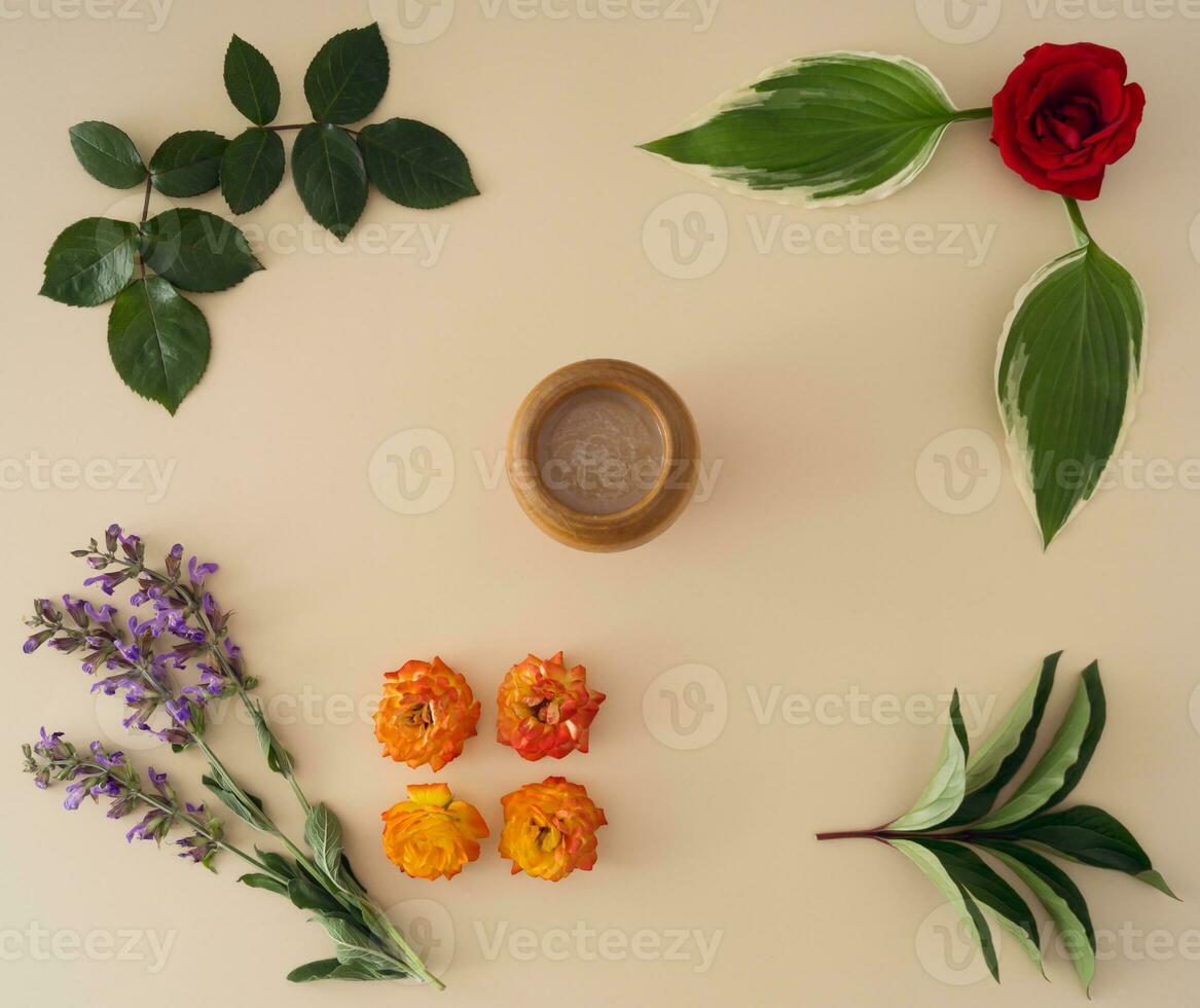 Creative minimal layout made of flowers, green leaves and cup of coffee. Nature composition idea. Coffee flat lay concept. Flowers aesthetic. photo