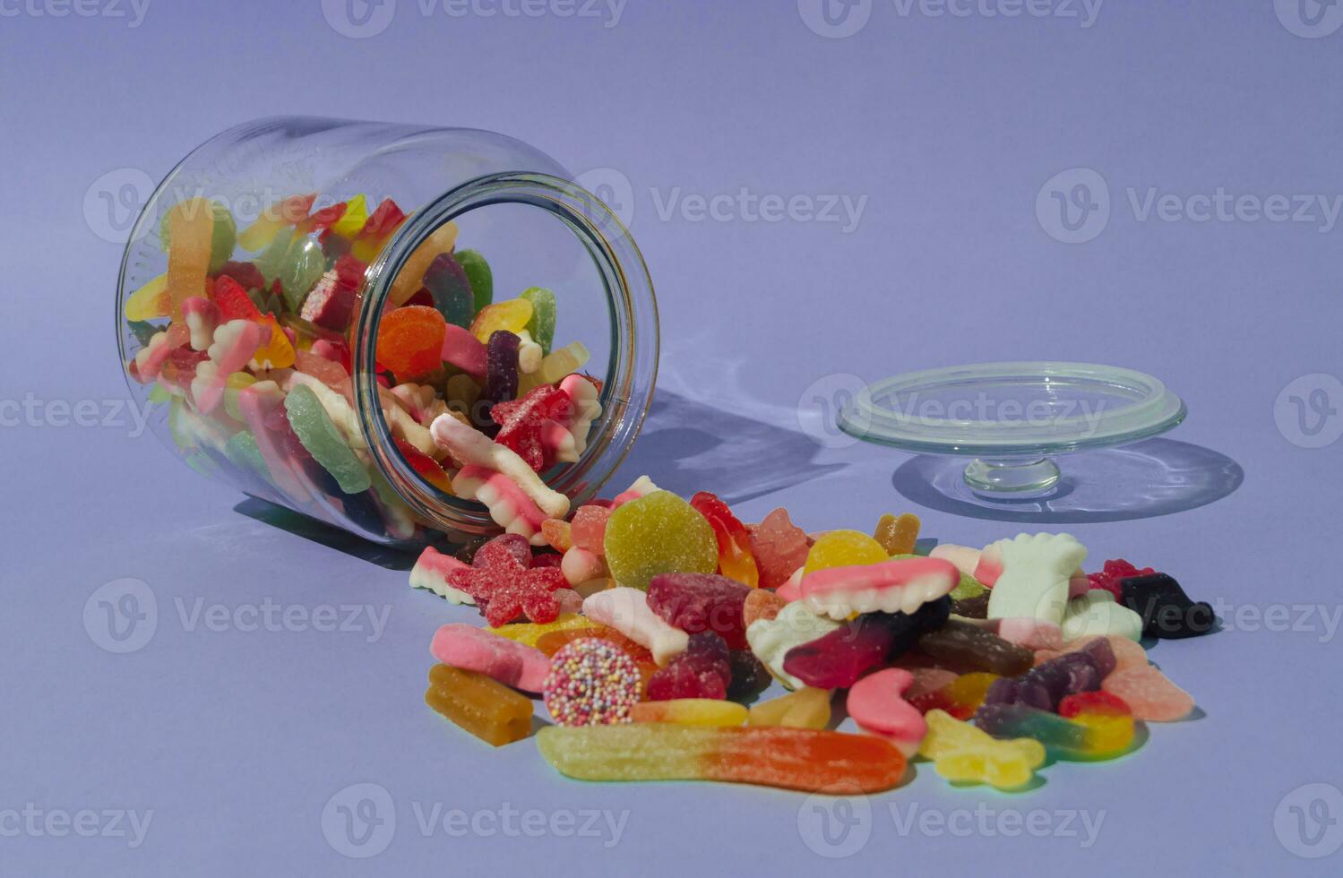 Creative layout made of colorful gummy candies on pastel violet background. Trendy decor design. Minimal concept. photo