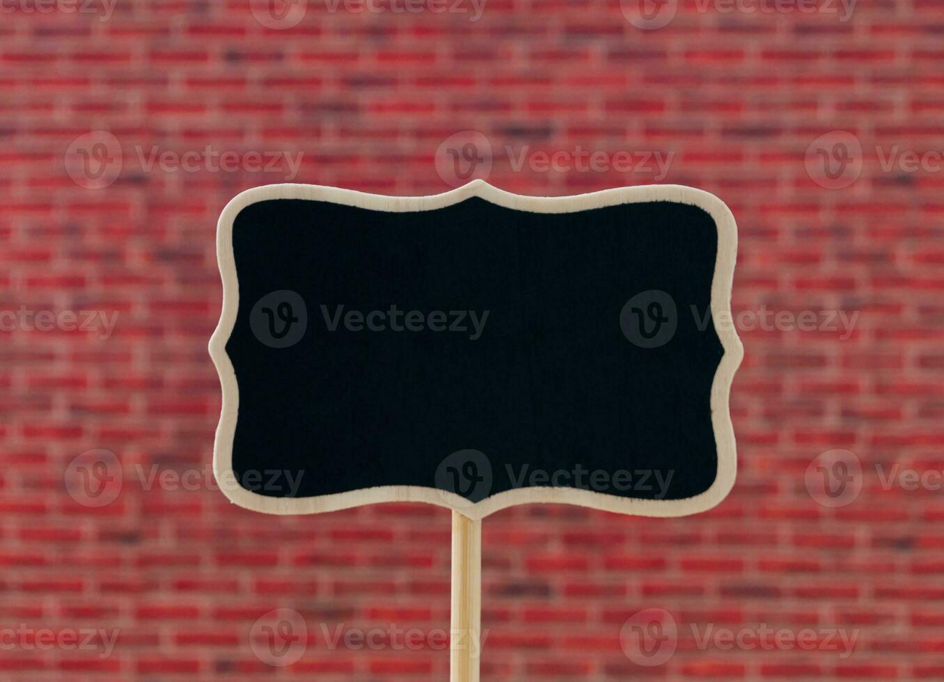 Creative layout made of black writing board against red brick wall background.  Minimal black writing board concept. Trendy background with copy space idea. photo