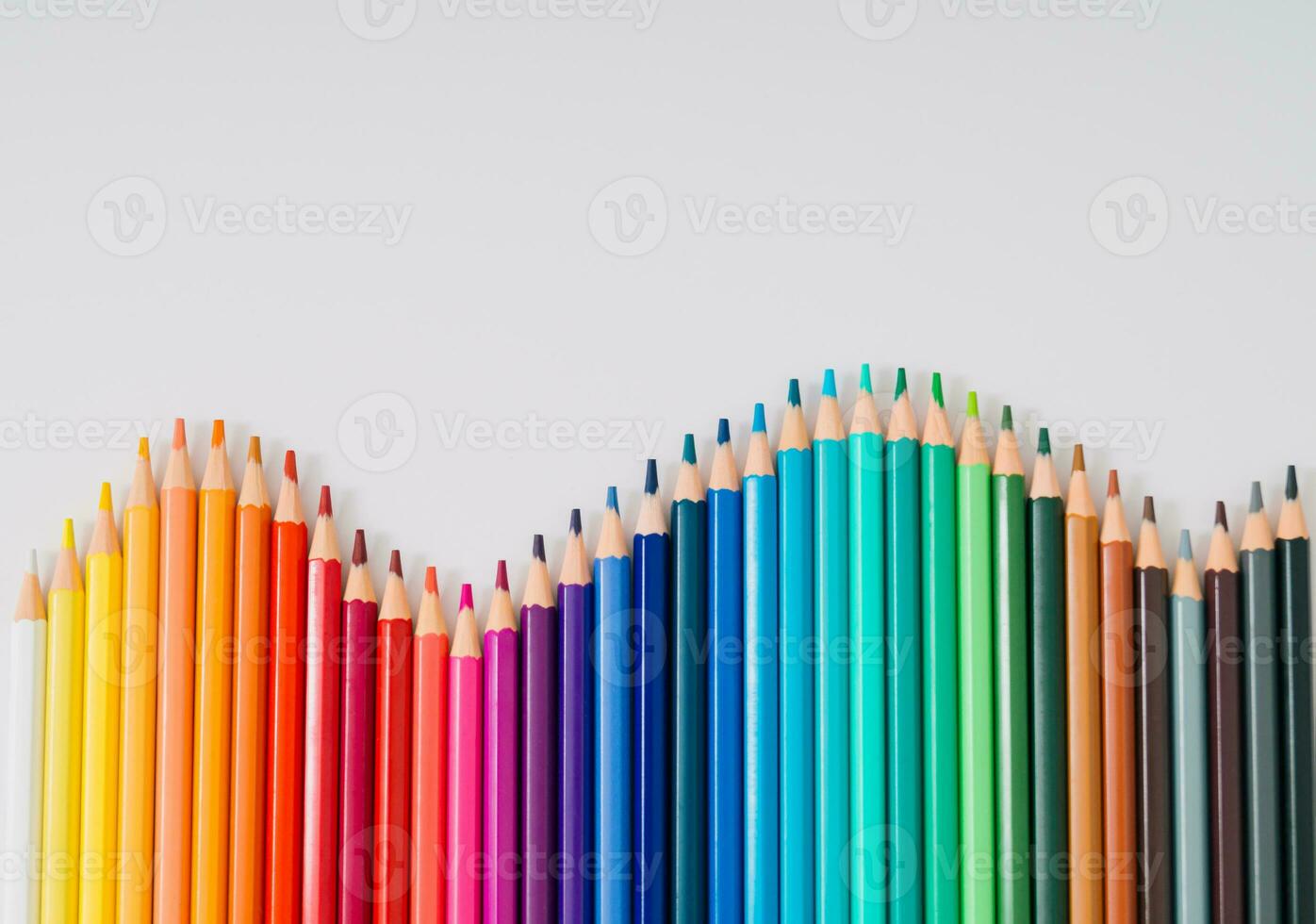 Back to school. Creative layout made of colored pencils on white background. Minimal colored pencils concept. Trendy flat lay school idea. Top of view. Copy space. photo