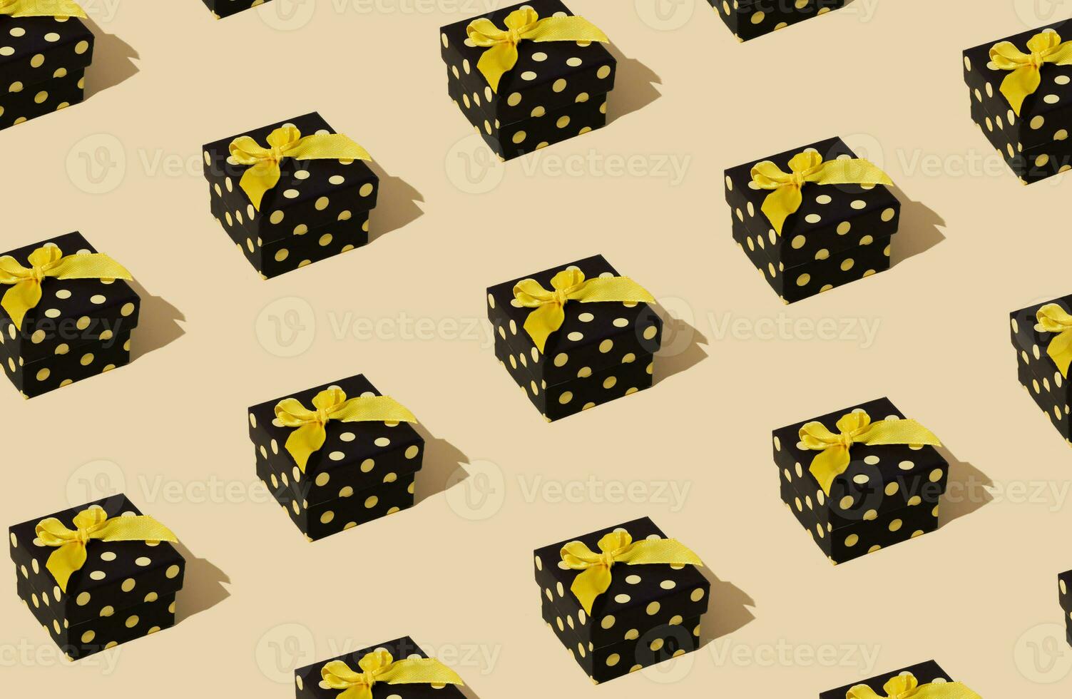 Minimal pattern composition background of yellow and black Christmas gift box. New Year concept. Trendy present pattern background idea. photo