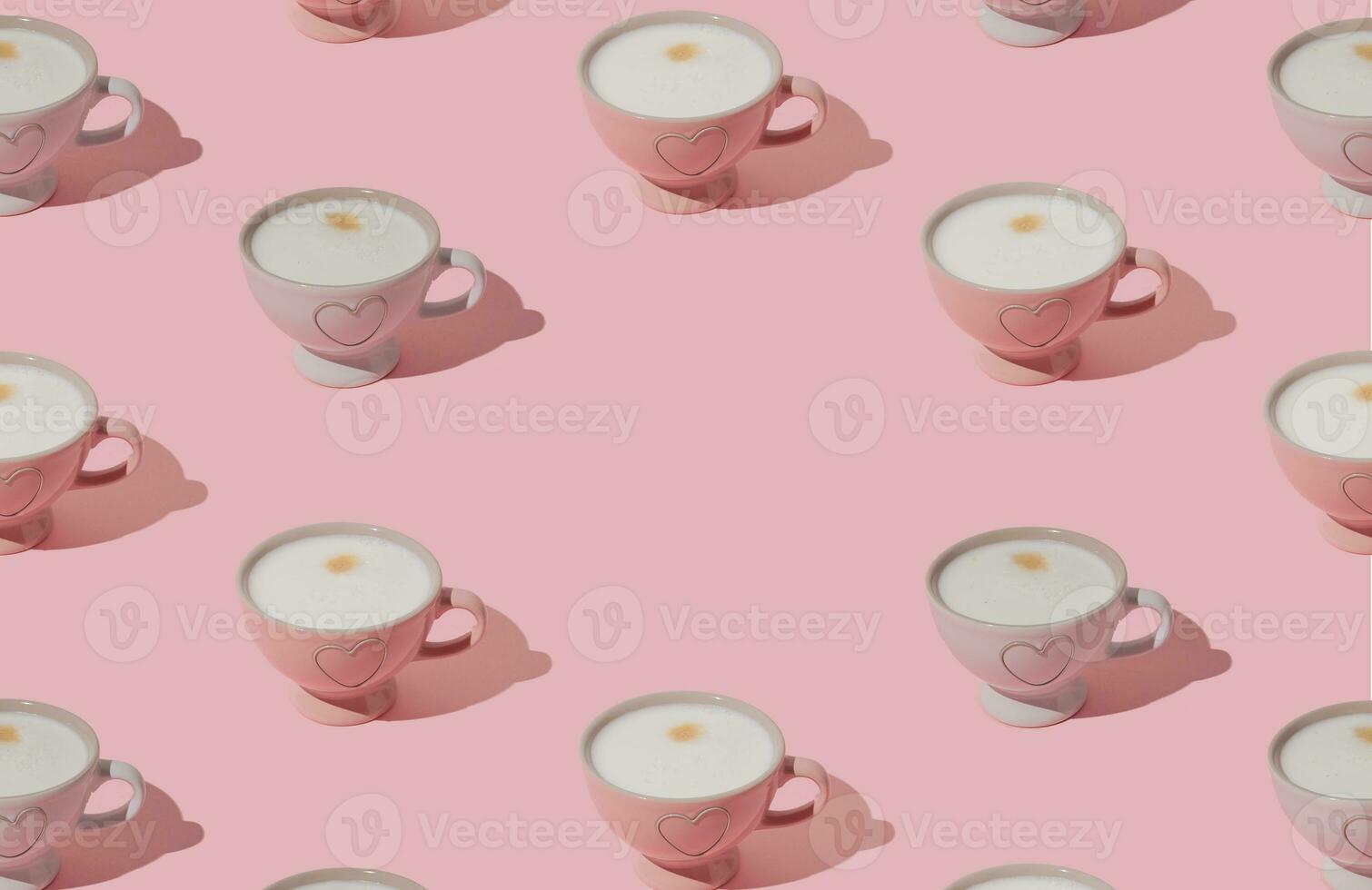 Trendy pattern made of pink and white cup of coffee on pastel pink background with copy space. Creative coffee concept. Minimal pattern background idea. Coffee aesthetic. photo