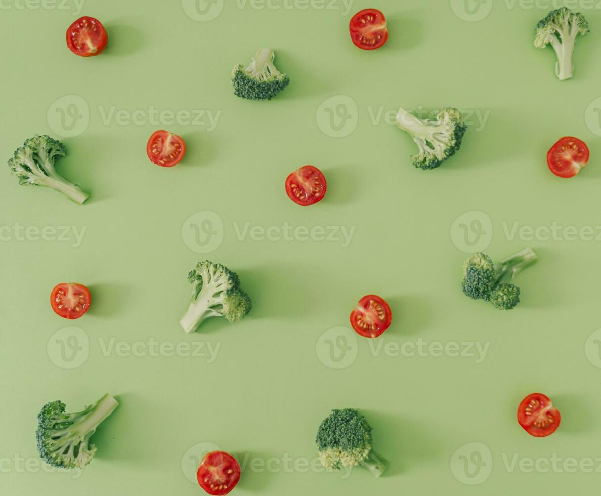 Trendy food pattern made of broccoli and cherry tomatoes on pastel green background. Creative vegetable pattern idea. Flat lay broccoli and cherry tomatoes composition. Vegetable aesthetic. photo