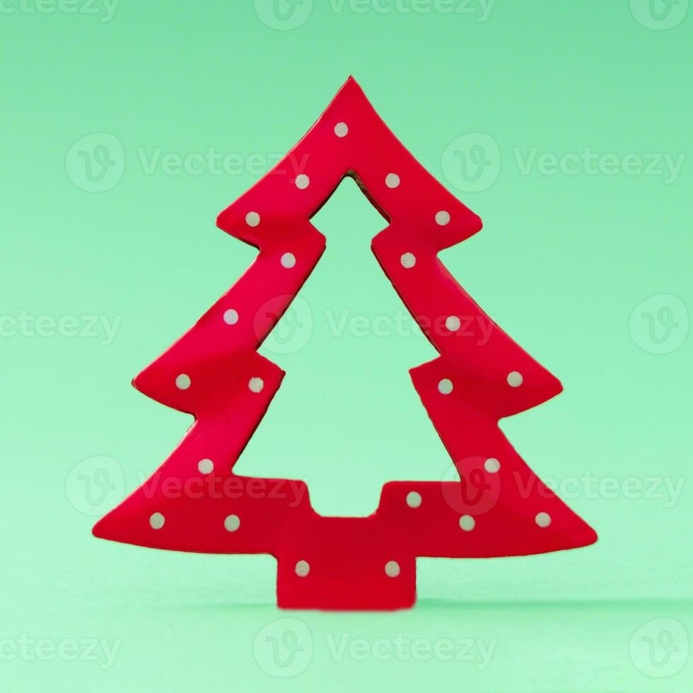 Minimalistic Christmas tree on pastel green background. Creative Christmas or New Year concept. Trendy holiday idea with copy space. photo