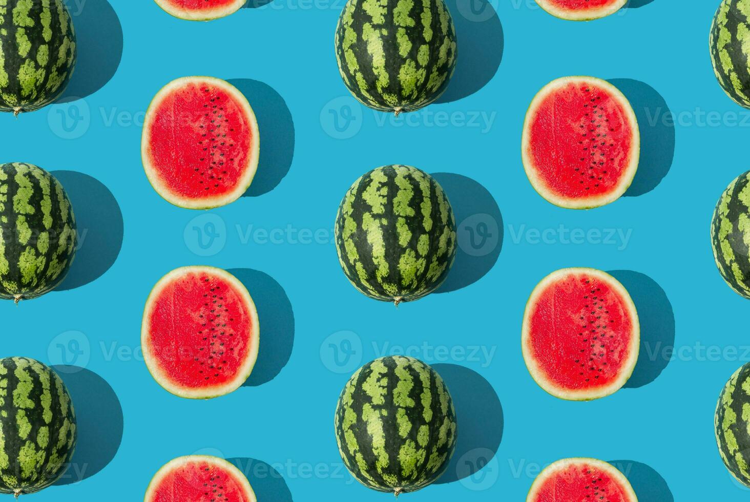 You are one in a melon. Trendy summer fruit pattern made of watermelon on light blue background. Natural food background concept. Minimal watermelon pattern idea. Summer fruit aesthetic. Flat lay. photo