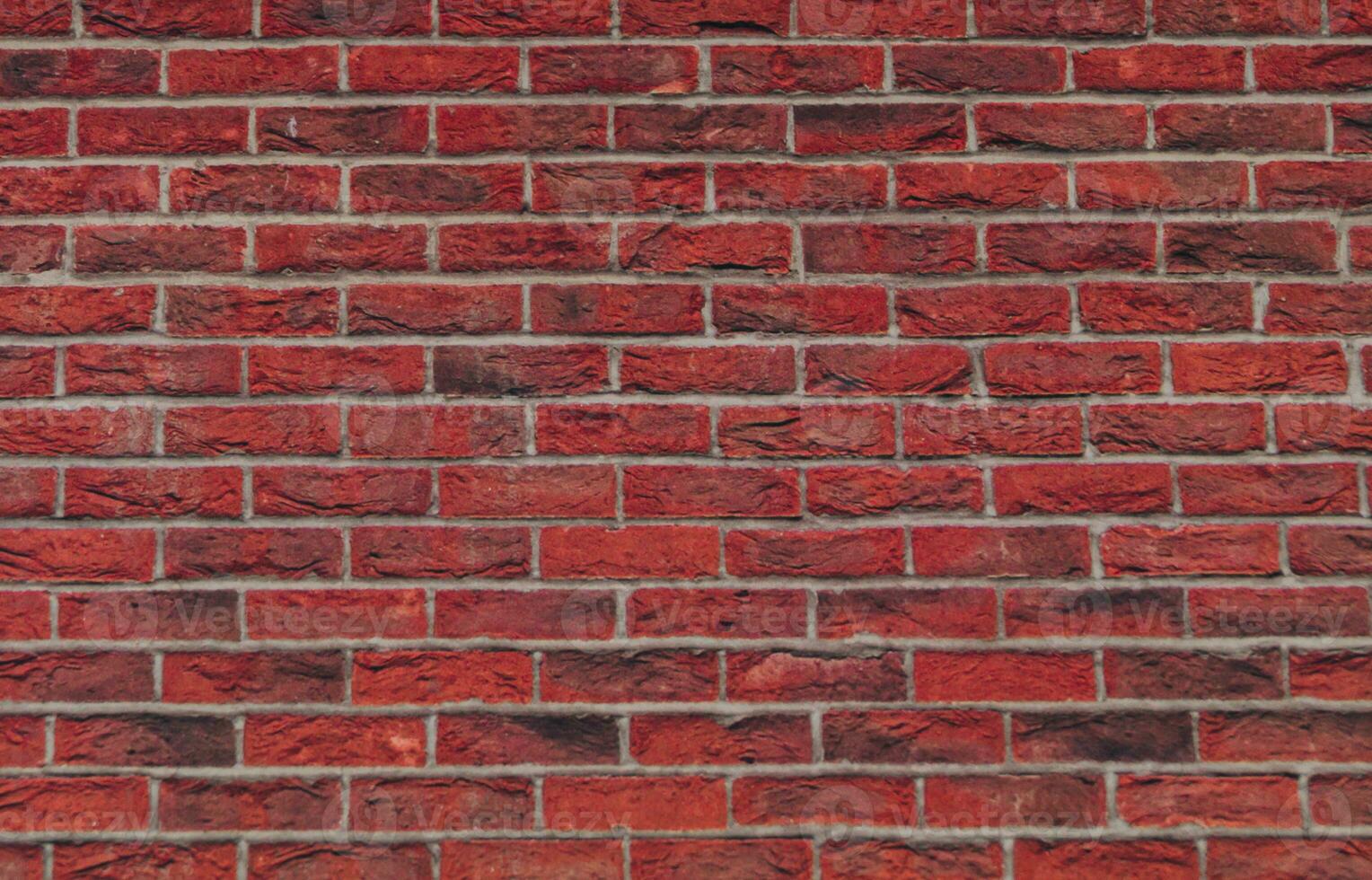 Close up view of a red brick wall. Texture of old dark brown and red brick wall panoramic background. Minimal pattern background concept. Trendy brick wall background idea. Copy space. photo