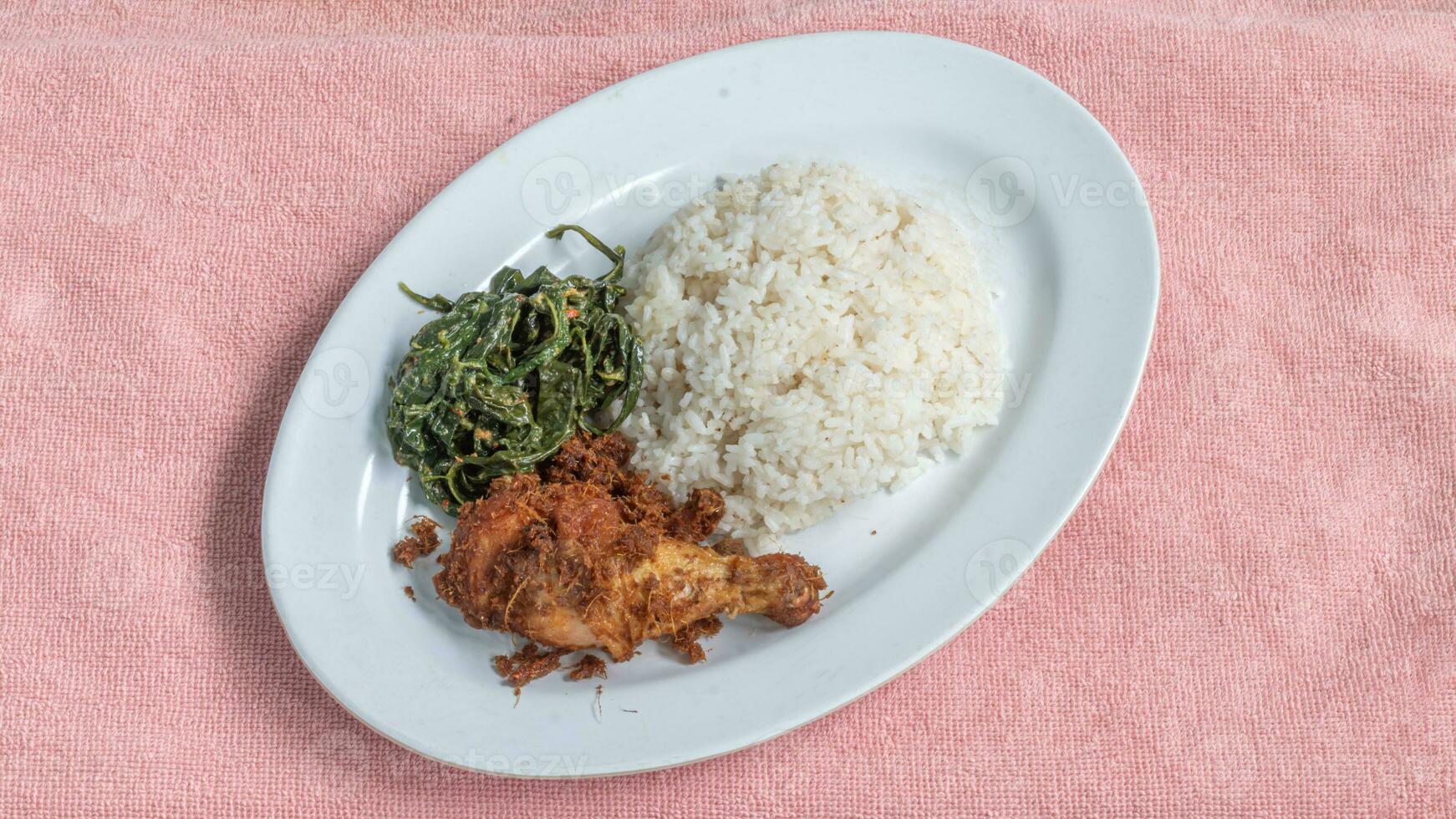 Ayam goreng Kalasan and Gulai daun ubi, Indonesian traditional cuisine made from fried chicken photo