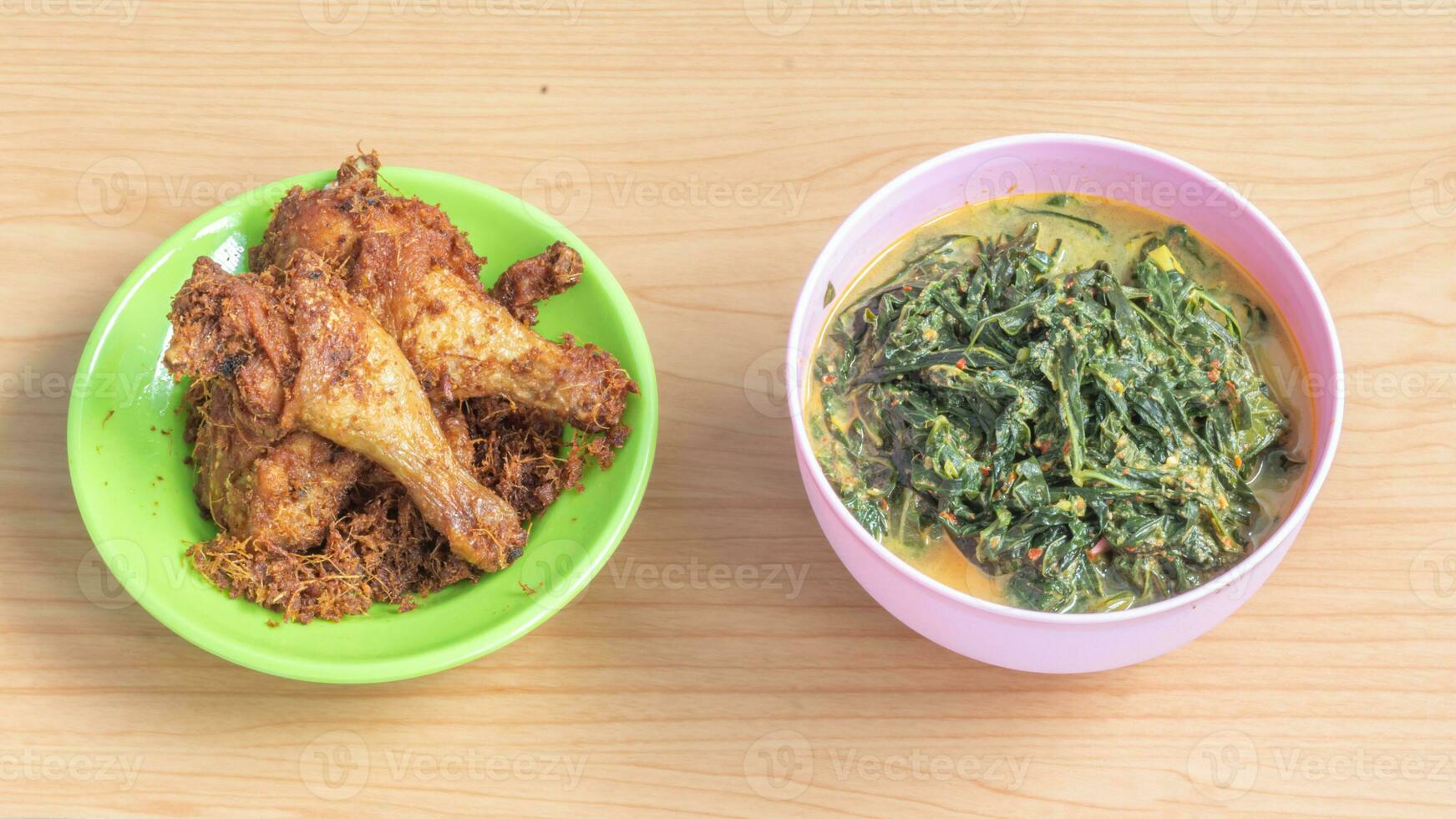 Ayam goreng Kalasan and Gulai daun ubi, Indonesian traditional cuisine made from fried chicken photo