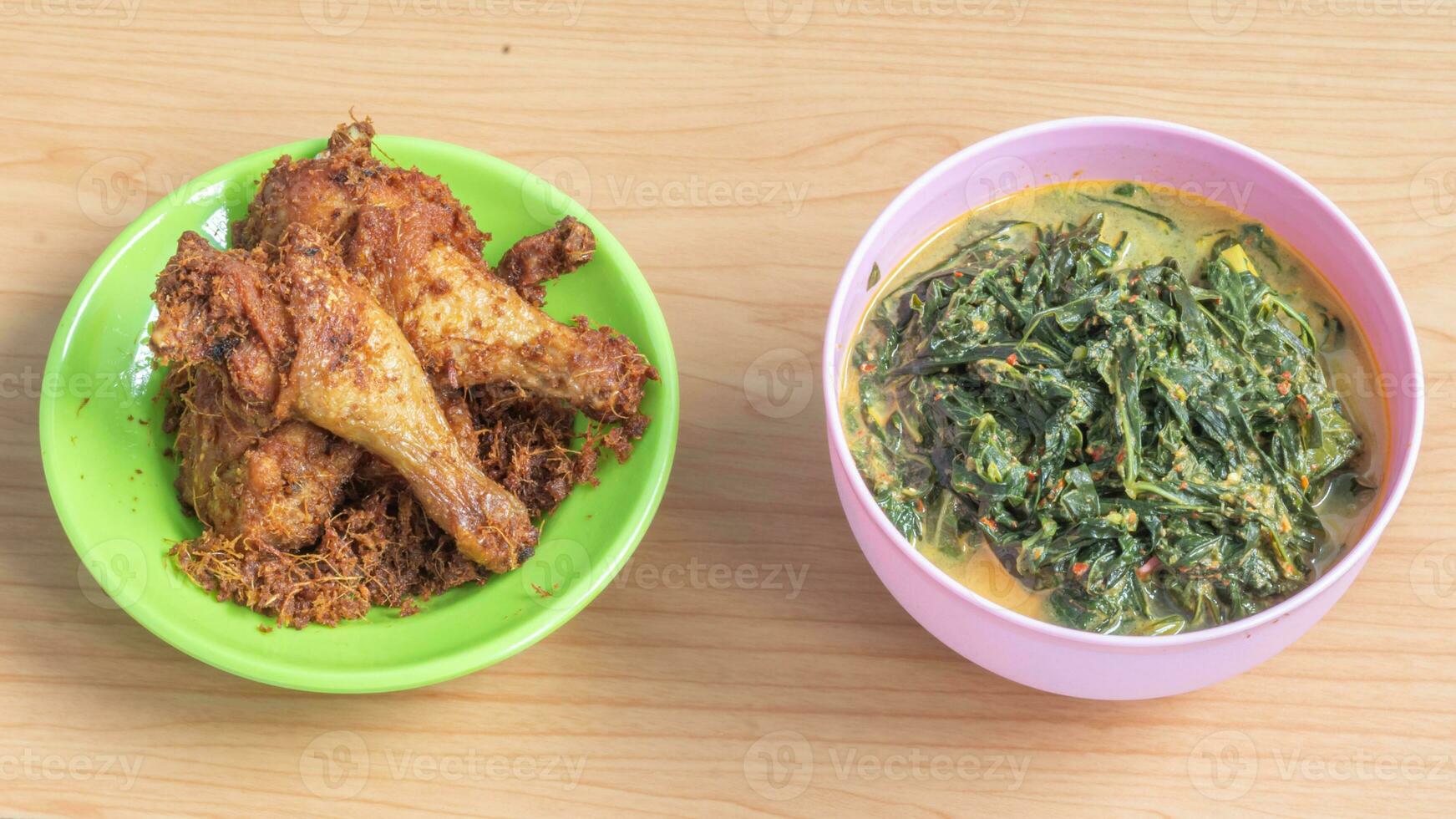 Ayam goreng Kalasan and Gulai daun ubi, Indonesian traditional cuisine made from fried chicken photo