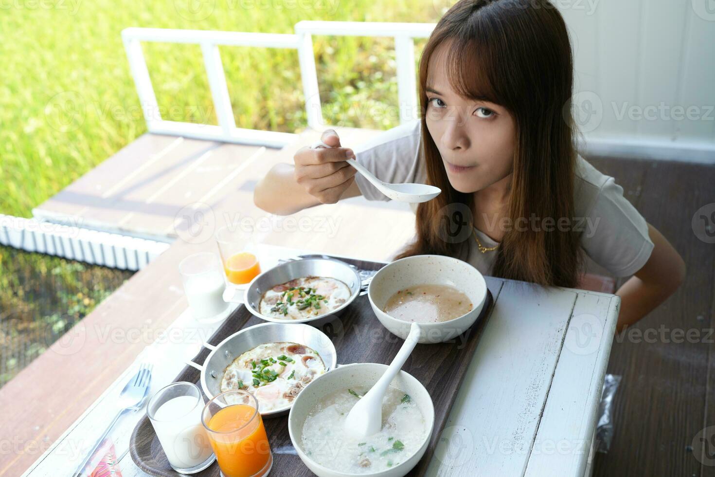 Asian female tourists eating breakfast photo