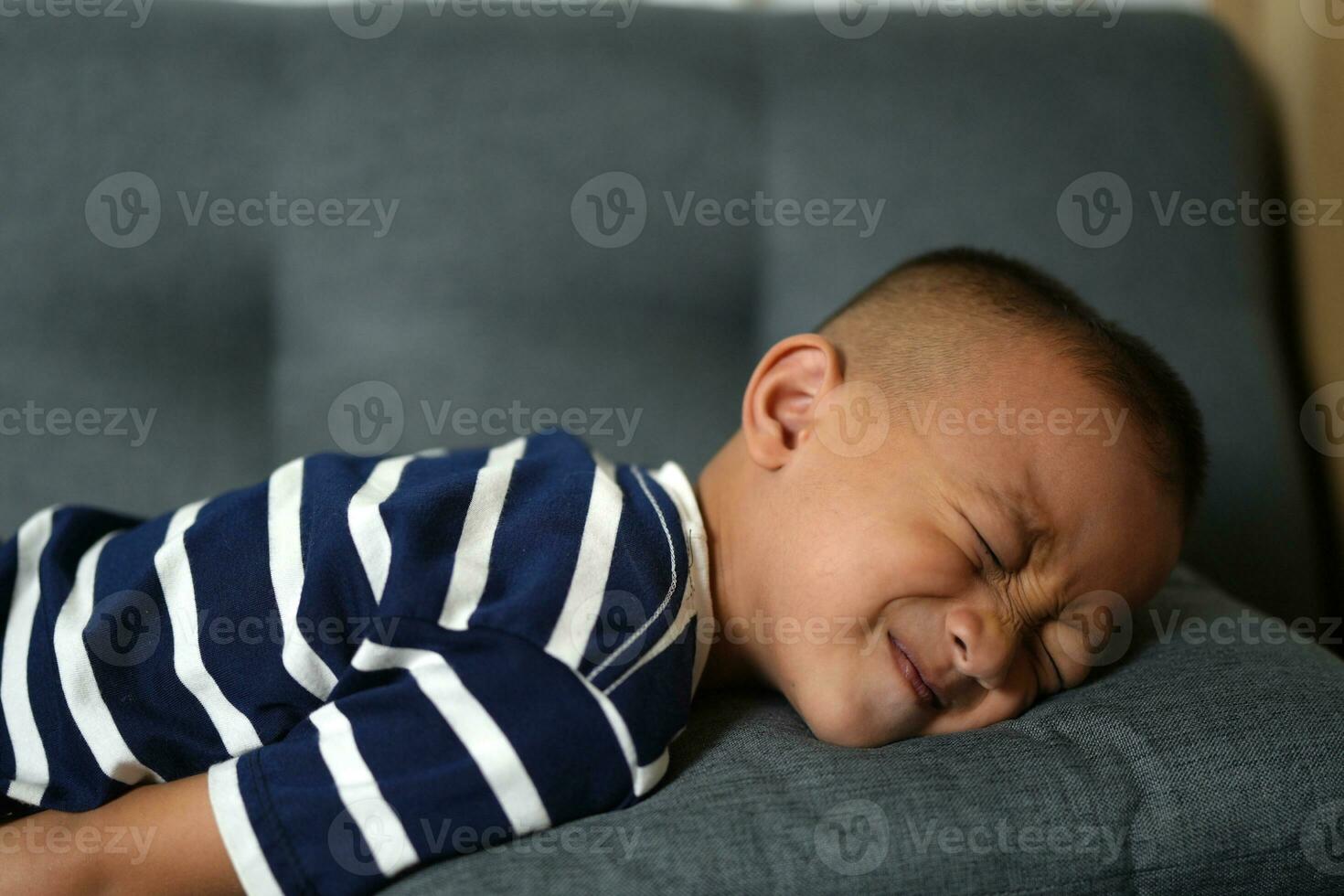 Asian boy has stomach pain from food poisoning photo