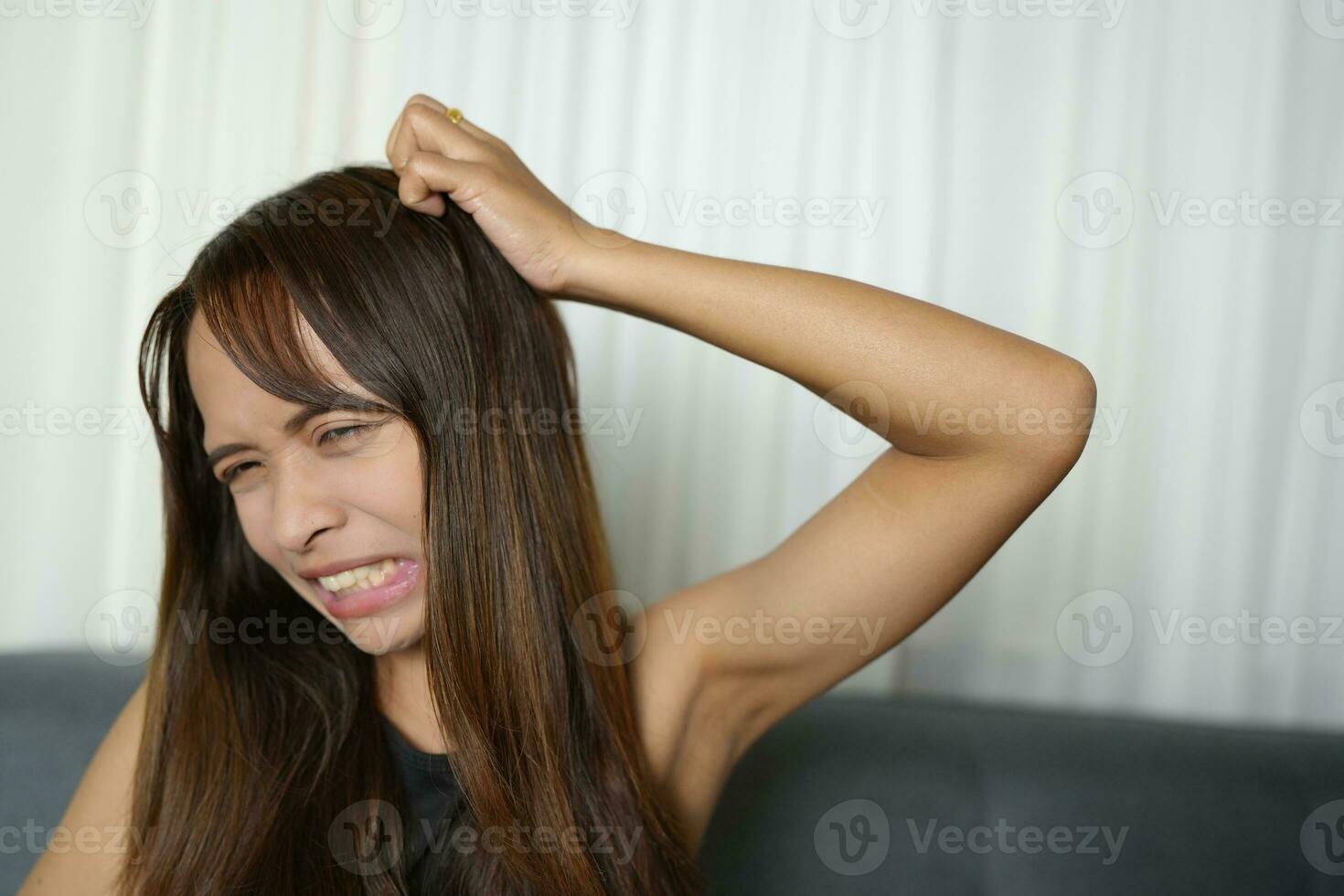 Asian woman has itchy scalp photo