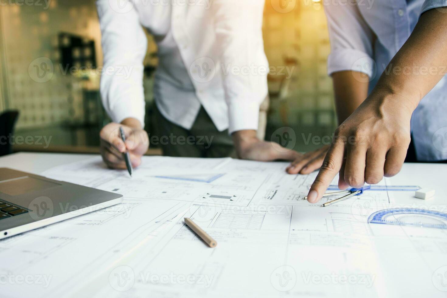 Structural engineering designers are working on the blueprints and analyzing them together. photo