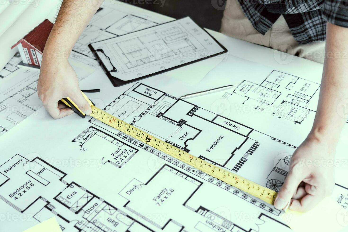 Architects are working on a new project while using a tape measure. photo