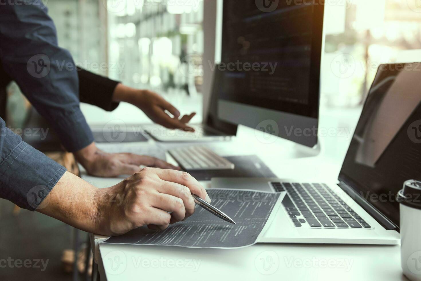 Two software developers are analyzing together about the code written into the program on the computer. photo