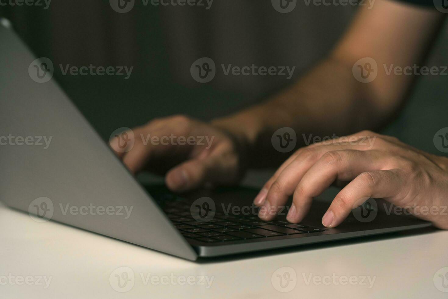 Close up hand using laptop computer on desk. photo