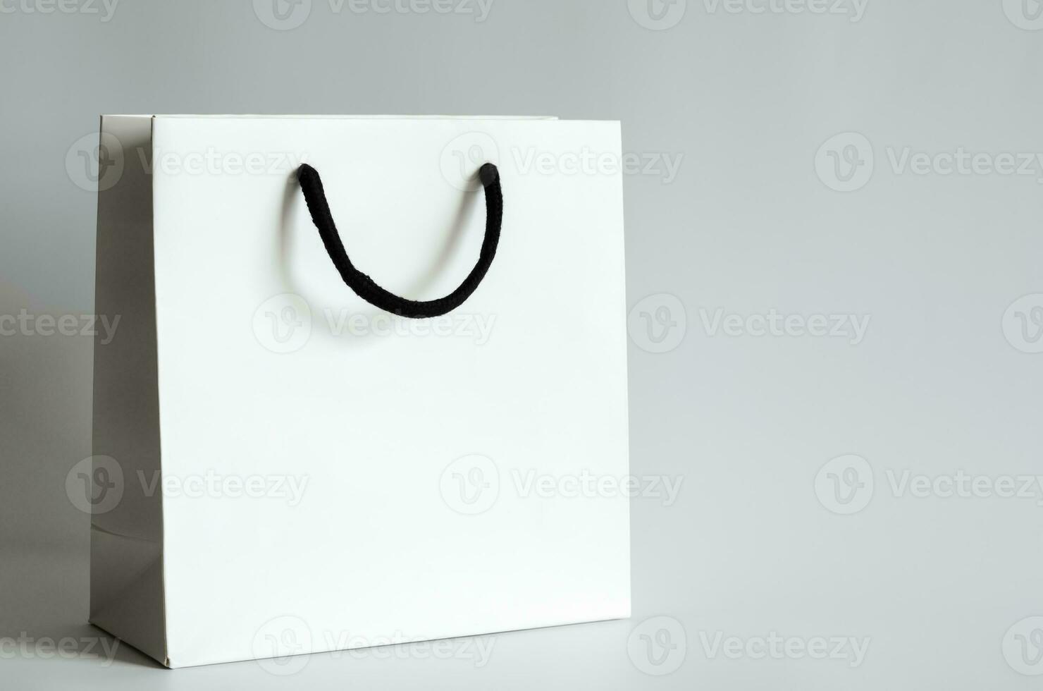 White shopping paper bag on white background for Black Friday shopping sale concept. photo