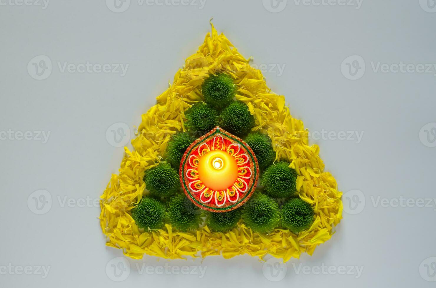 Clay diya lamp lits to celebrate for Diwali festival with colorful  flowers on white background. photo