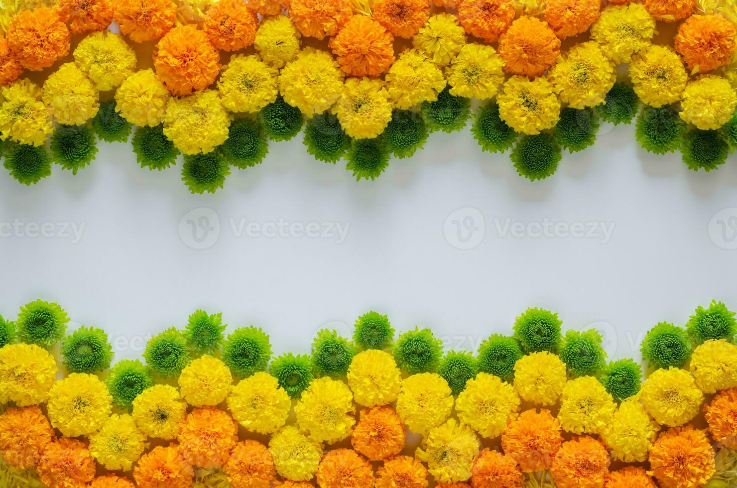 Decorative rangoli made from colorful marigold flowers and green Chrysanthemum for Diwali festival on white background with space for text. photo