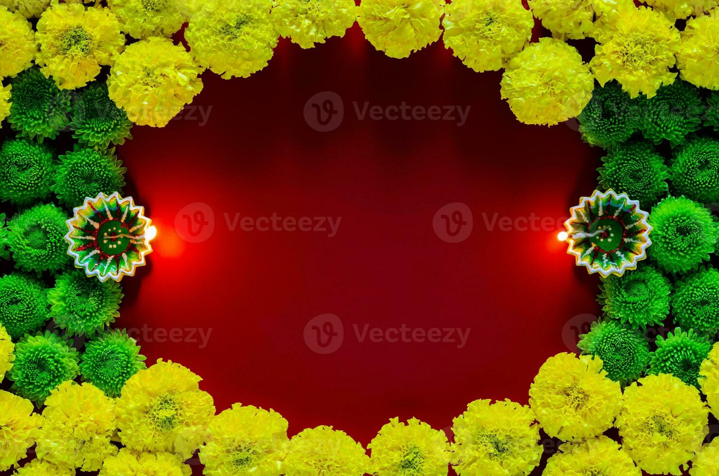 Clay diya lamps lit to celebrate for Diwali festival with colorful flowers on empty dark red background. photo