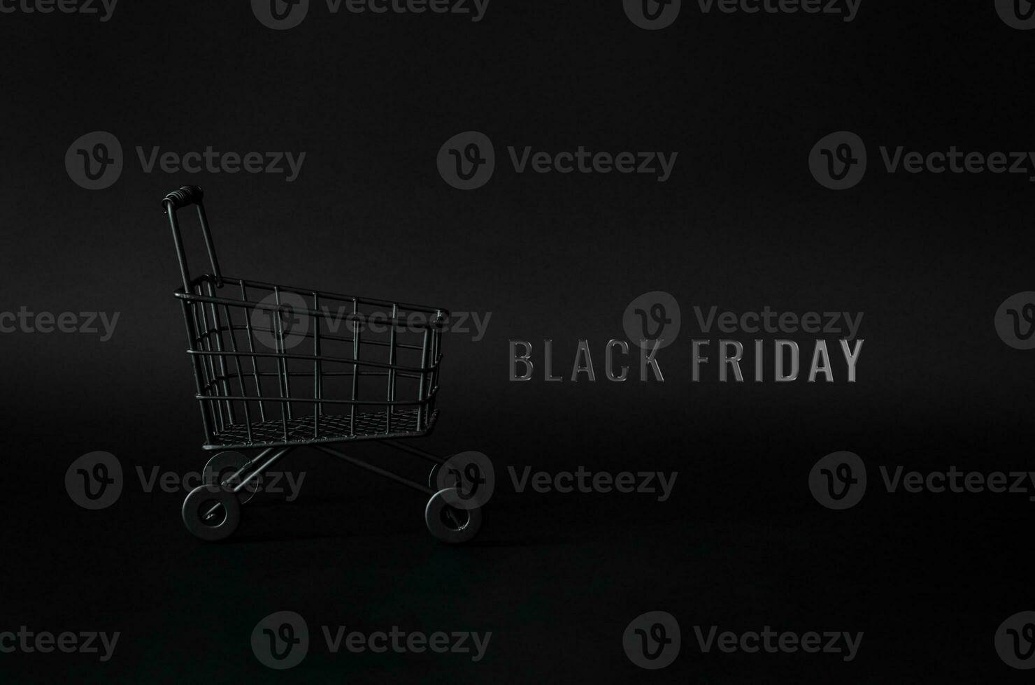 Black shopping cart with word Black Friday on black background for Black Friday shopping concept. photo